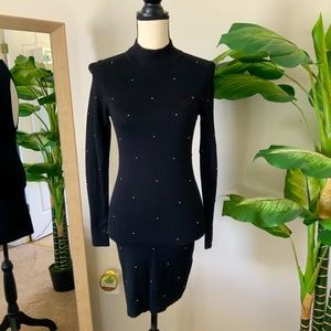 Black form fitting evening dress with open back